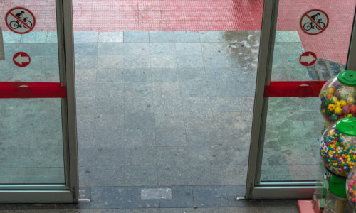 Open automatic door at the entrance of a shopping mall